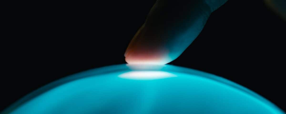 human finger interacts with artificial intelligence