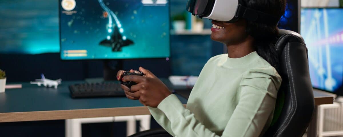 Pro gamer woman wearing virtual reality googles holding gaming controller