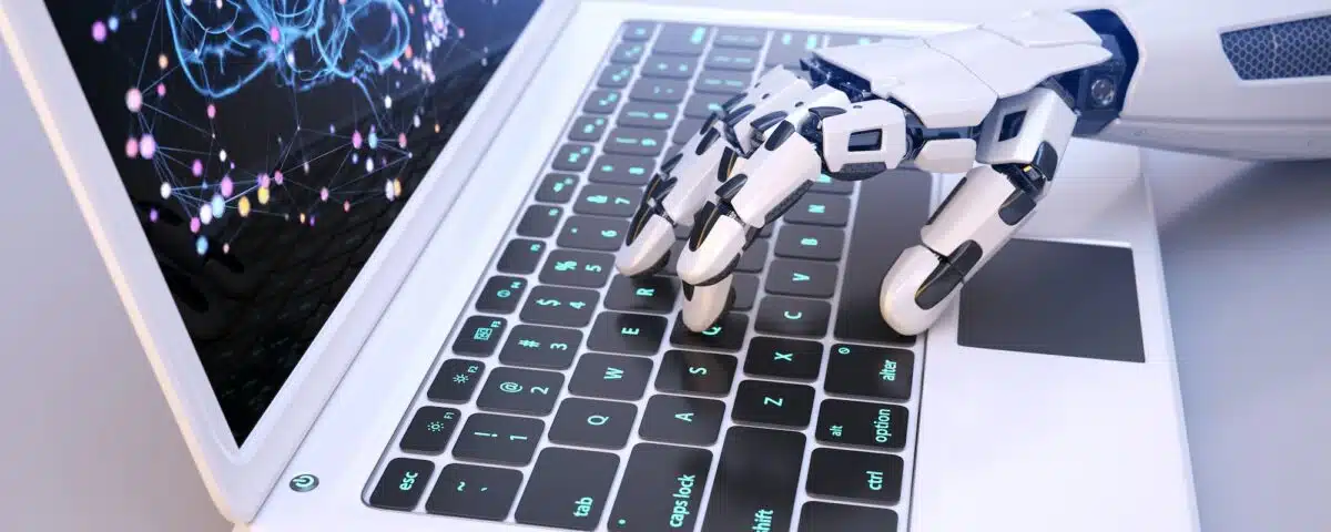 Robot's hand typing on keyboard