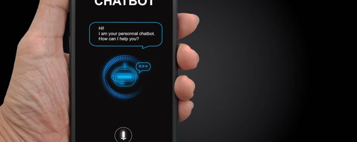 A man's hand holding mobile smartphone with chatterbot application