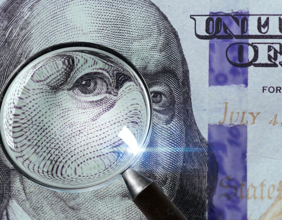 100 US Dollar under magnifying glass