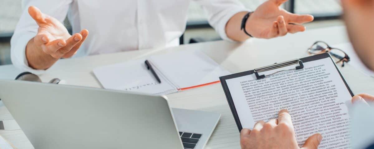 cropped view of translator working with businessman and documents in office