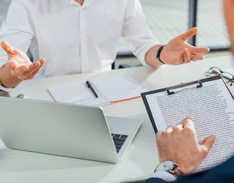 cropped view of translator working with businessman and documents in office